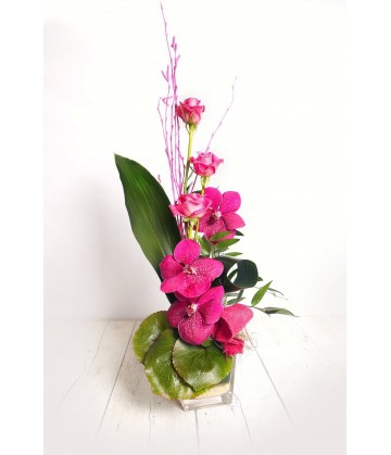 Arrangement three pink orchids in a  crystal vase