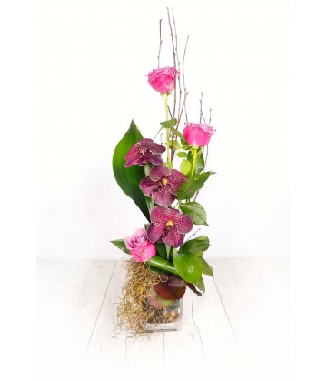 Arrangement three pink orchids in a  crystal vase